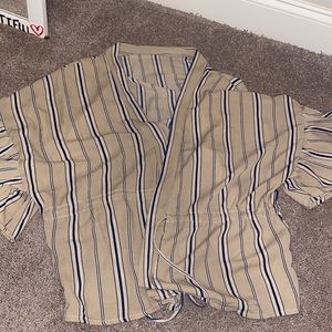 Short sleeve tan shirt with navy stripes.